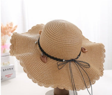 Straw hat with leather bow